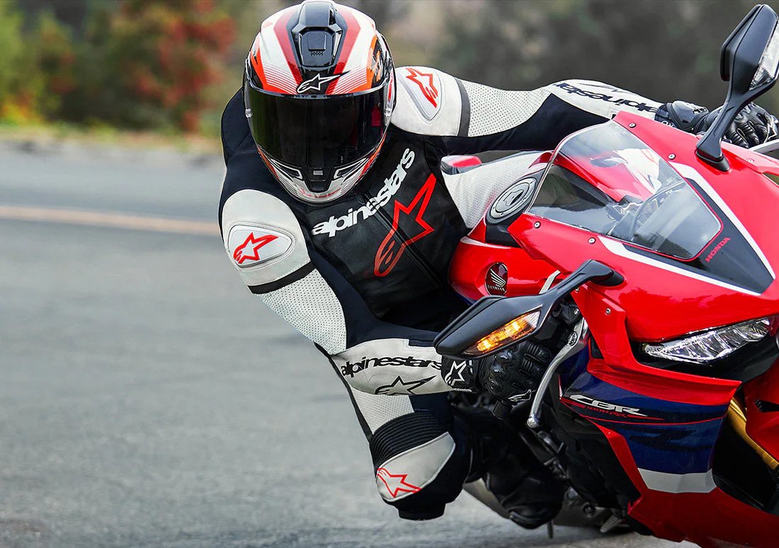 Rider on a sportbike at a track, wearing a leather suit with the distinct outline of the Tech-Air 7x back protector visible.