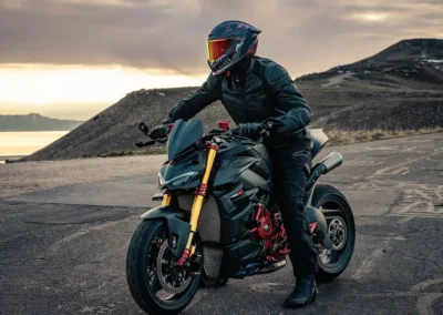 Ruroc EOX motorcycle helmet in a matte black finish, showing its aerodynamic profile and Quad-Matrix carbon fiber shell.