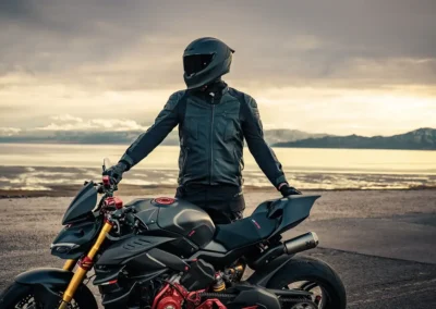 Ruroc EOX motorcycle helmet in a matte black finish, showing its aerodynamic profile and Quad-Matrix carbon fiber shell.