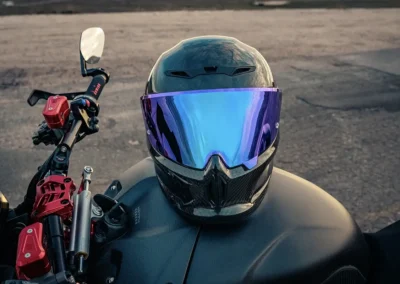 Ruroc EOX motorcycle helmet in a matte black finish, showing its aerodynamic profile and Quad-Matrix carbon fiber shell.