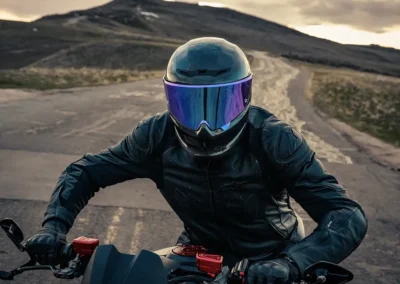 Ruroc EOX motorcycle helmet in a matte black finish, showing its aerodynamic profile and Quad-Matrix carbon fiber shell.