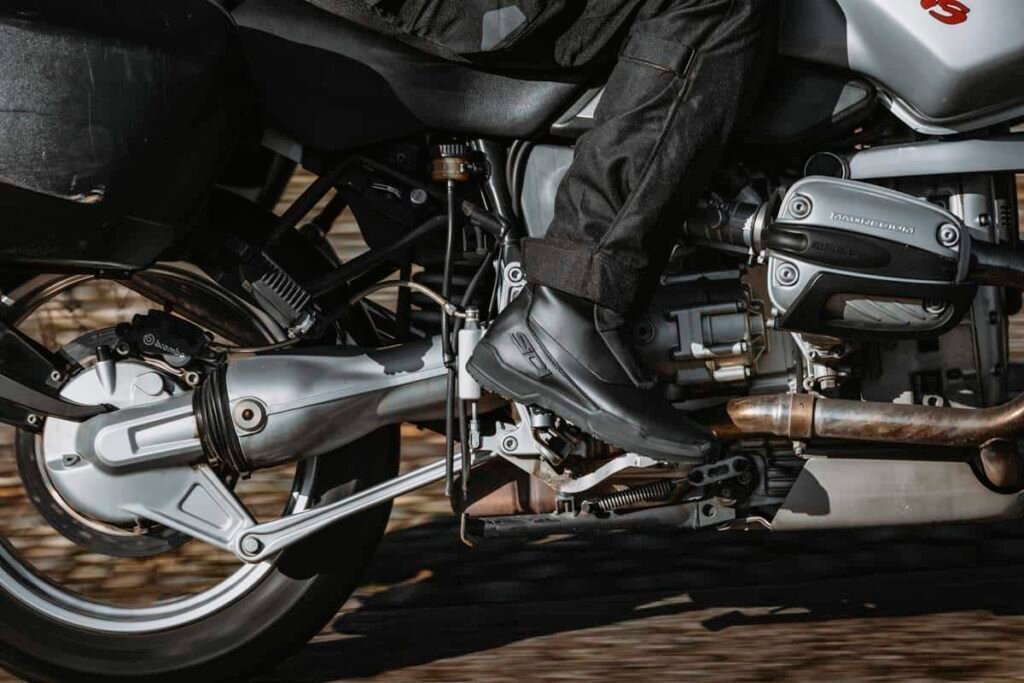 A rider wearing Sidi Orion GTX boots resting their foot comfortably on the footpeg of a touring motorcycle.
