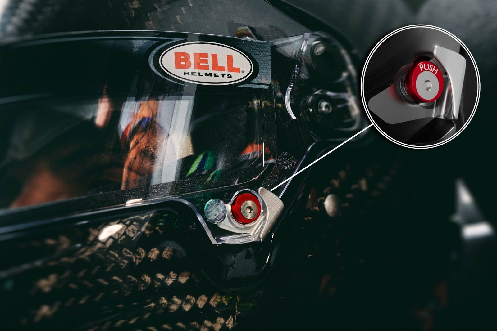 The front view of a Bell racing helmet, highlighting the unobstructed and aerodynamic chin bar.