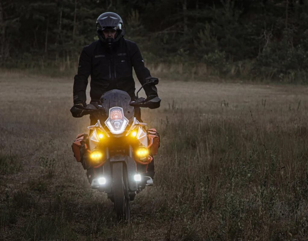 Rider snapping the interchangeable selective yellow X-Lens onto the center of the Denali D7 PRO light pod.