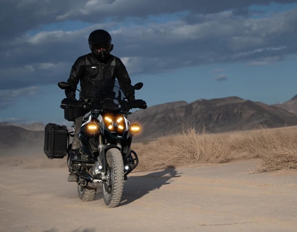 Rider snapping the interchangeable selective yellow X-Lens onto the center of the Denali D7 PRO light pod.