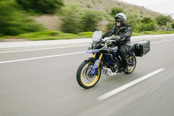 A rider wearing the HJC RPHA 91 Carbon helmet on a touring motorcycle, demonstrating its aerodynamic profile