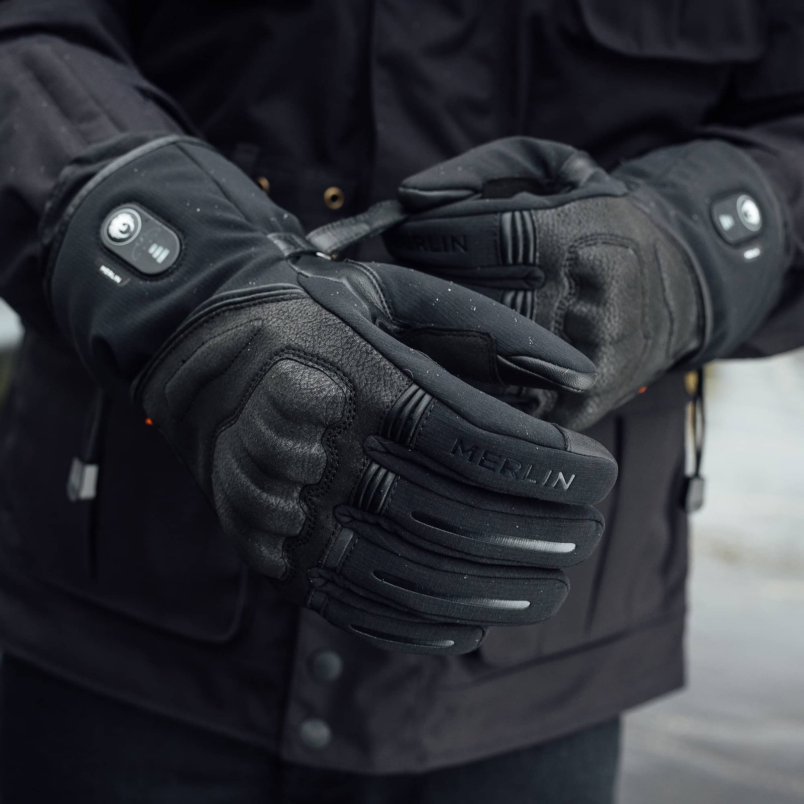 The Merlin Curborough D3O Heated Glove in brown ripstop cotton and leather, shown against a dark background.