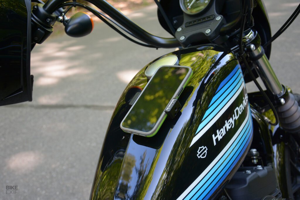 A smartphone secured within the spring-loaded, silicone-padded grips of the Freakmount Billet.