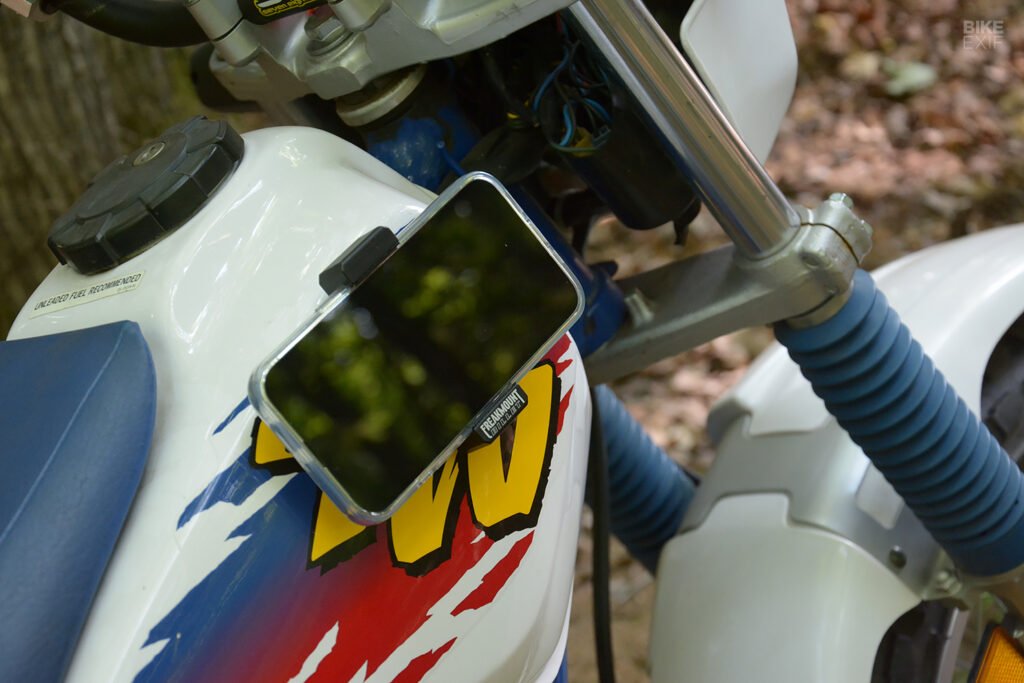 A smartphone secured within the spring-loaded, silicone-padded grips of the Freakmount Billet.